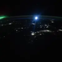NASA Astronaut Captures Aurora and Moon Glowing Over US