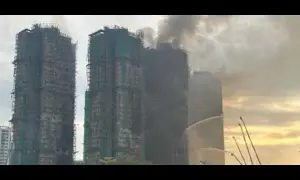 Hong Kong firefighters battle apartment blaze for second day as toll rises